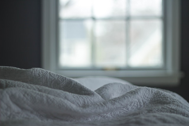 Image for the article "Why Sleep is the Foundation of Change" shows a window in the background and some white bed sheets in the front